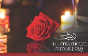 Image of a red rose and candles with the Steakhouse at Flying Horse logo